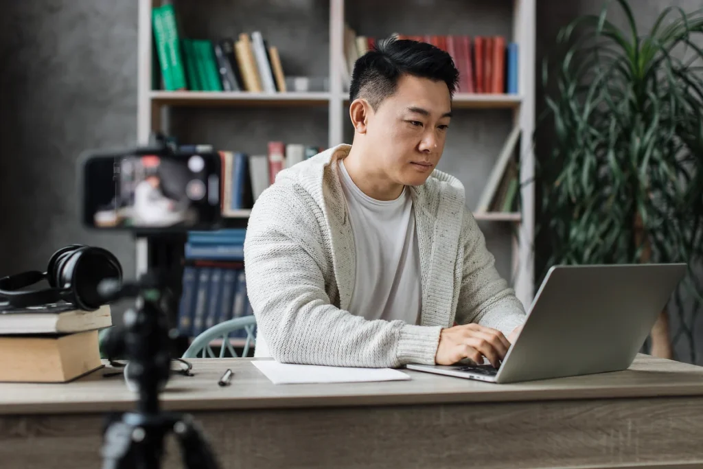 Subfort Attractive Asian Male Working On Laptop And Record